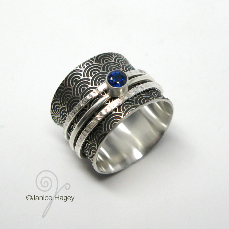 Water Pattern Spinner Ring with 2 Hammered Spinners and Sapphire